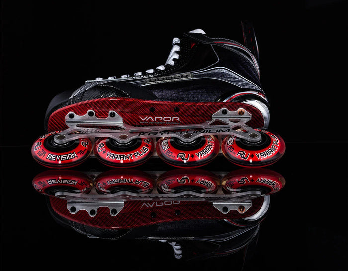 Bauer Vapor inline hockey skate with red Revision wheels, side view on black background
