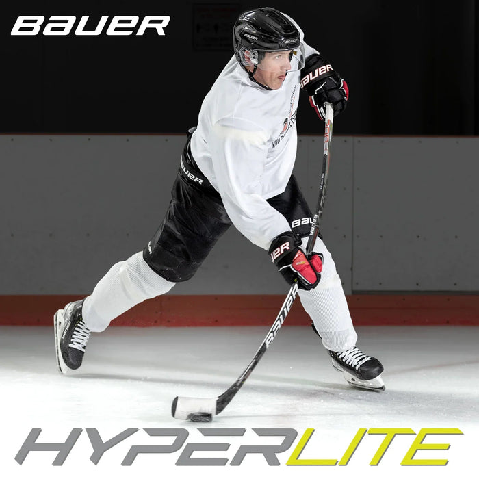 Hockey player in Bauer gear using Bauer Hyperlite stick on ice at TheHockeyShop.com rink.