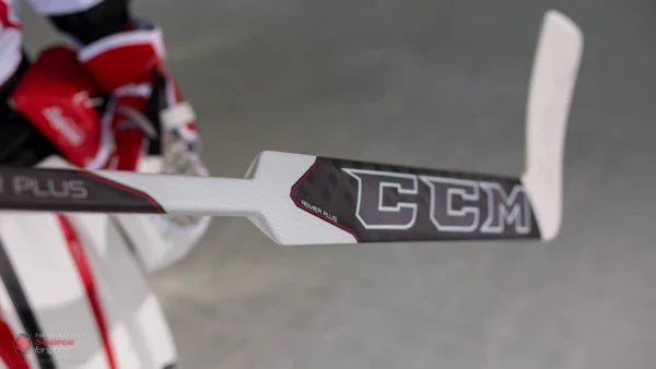 CCM Premier Plus goalie stick held on ice by hockey goalie in red and white gear