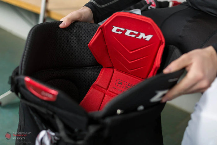 Close-up of CCM Quicklite hockey pants padding at TheHockeyShop.com locker room