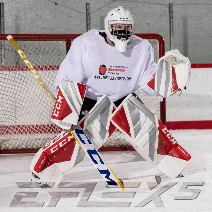 Hockey goalie in CCM EFlex5 pads and gear in front of net at TheHockeyShop.com rink.