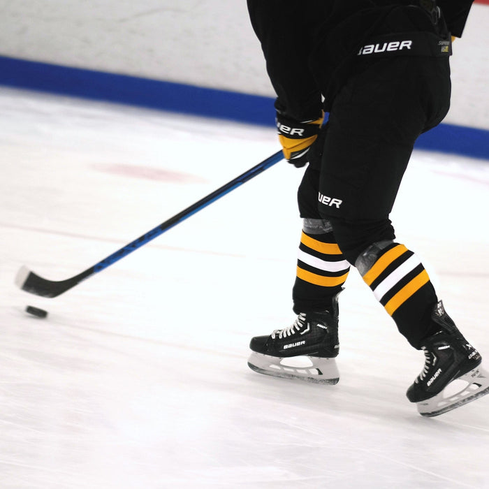 hockey player stickhandling the puck while skating