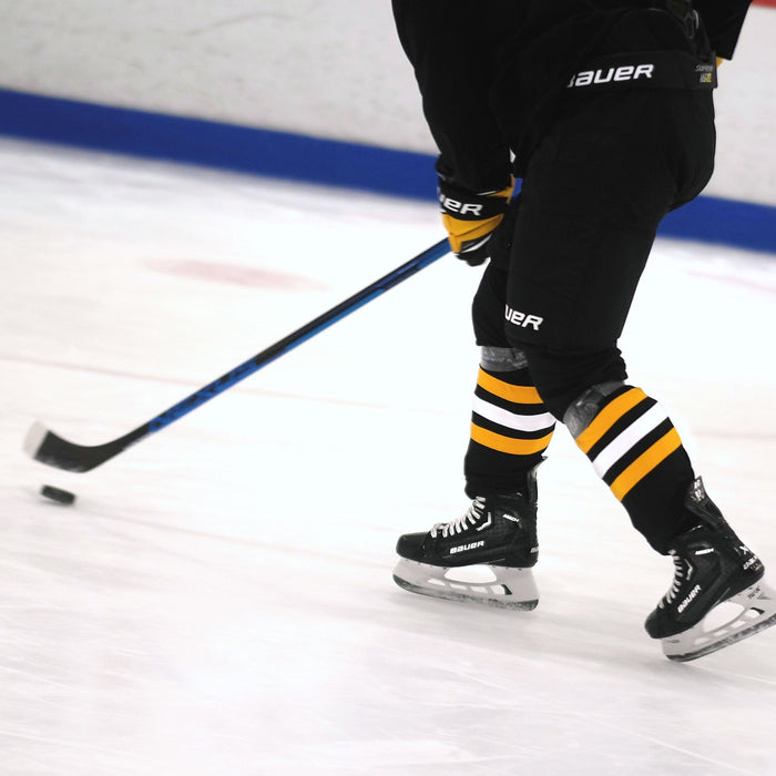 hockey player stickhandling the puck while skating