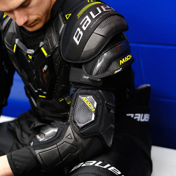 player putting on Bauer Mach protective gear