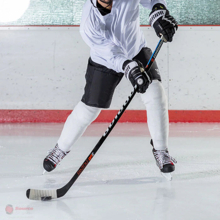 Hockey player using Warrior Fantom QRE stick and gloves on ice at TheHockeyShop.com
