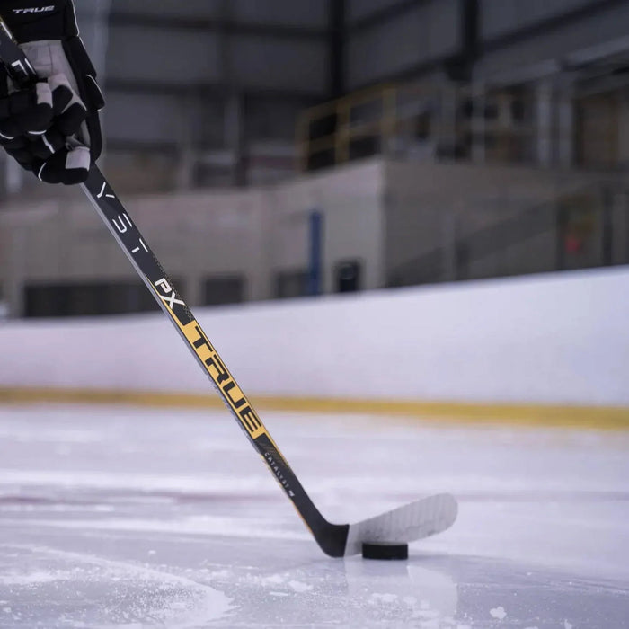True PX hockey stick on ice with puck at indoor rink, TheHockeyShop.com equipment