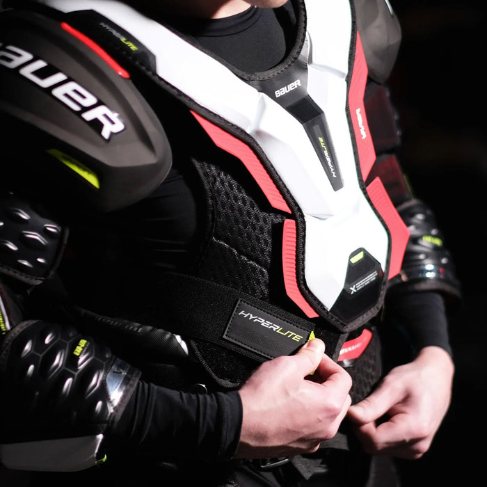 Bauer Hyperlite hockey shoulder pads worn by player, premium protective gear from The Hockey Shop