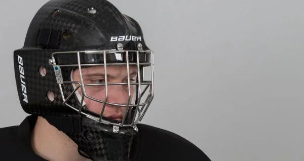 Hockey player wearing black Bauer goalie mask, featured by The Hockey Shop