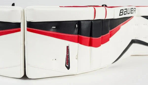 Bauer goalie leg pads in white, black, and red from The Hockey Shop hockey gear selection