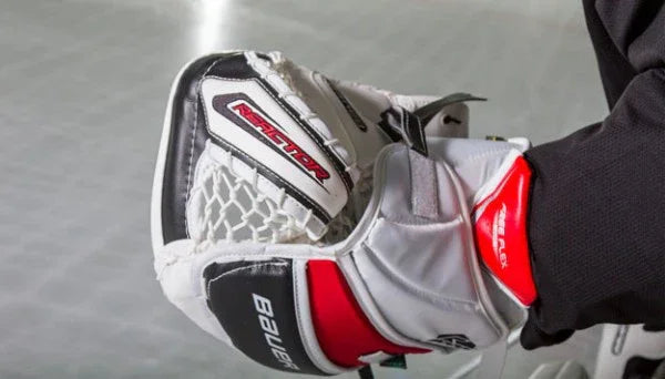 Bauer Reactor hockey goalie glove with red, white, and black design at The Hockey Shop