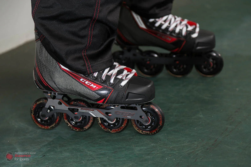 CCM Jetspeed inline hockey skates with black and red boots on green floor, The Hockey Shop