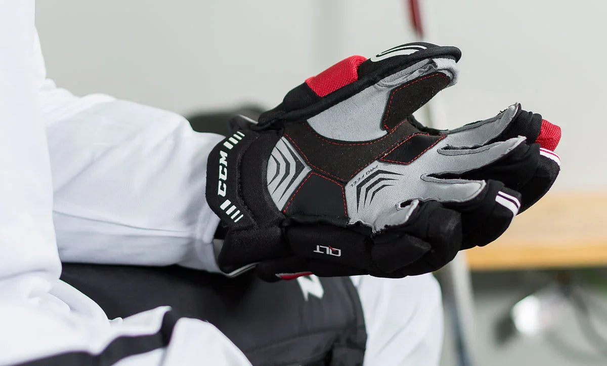 CCM Quicklite hockey glove close-up, black and red, at TheHockeyShop.com equipment store