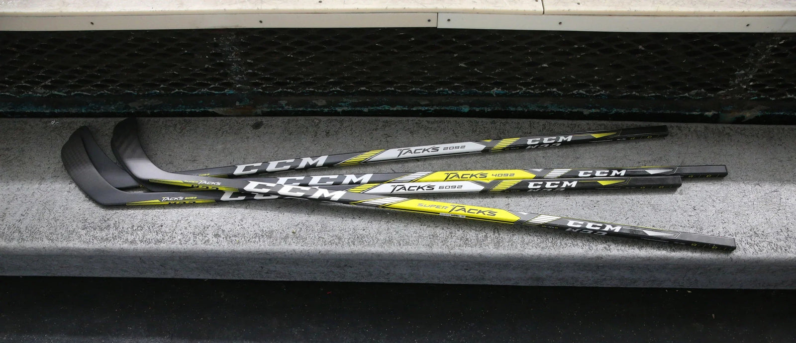 CCM Super Tacks hockey sticks on locker room bench at TheHockeyShop.com