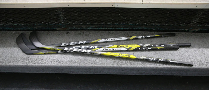CCM Super Tacks hockey sticks on locker room bench at TheHockeyShop.com