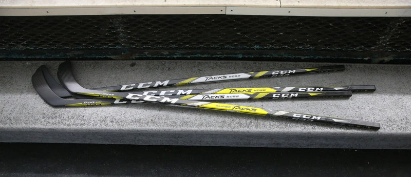 CCM Super Tacks hockey sticks on locker room bench at TheHockeyShop.com