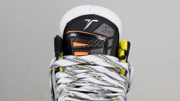 Close-up of CCM Tacks goalie skate tongue with D3O foam, black carbon design, and white laces