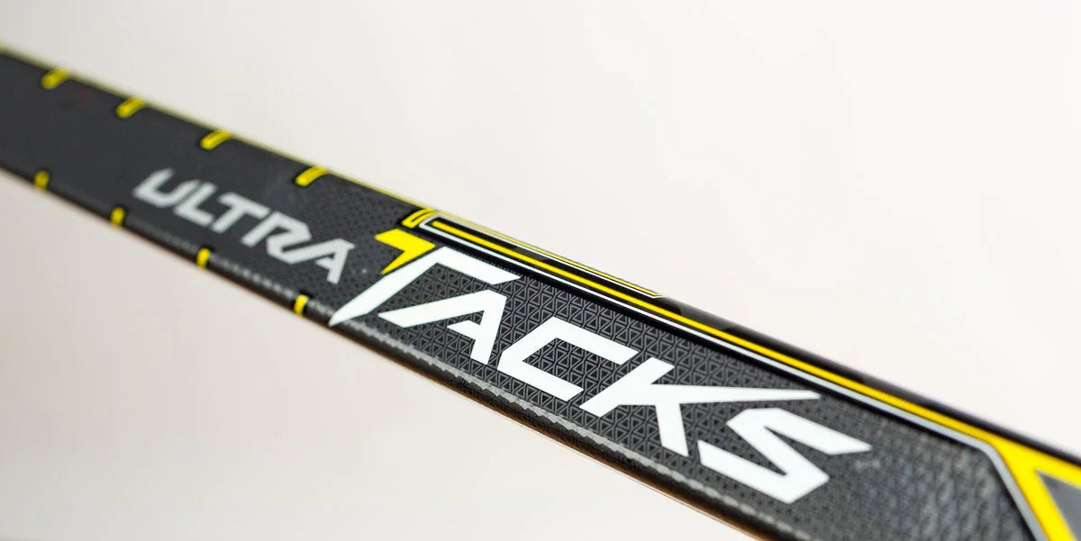 CCM Ultra Tacks hockey stick close-up, black with yellow accents, sold at The Hockey Shop