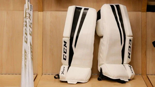 CCM YFlex goalie pads and sticks in locker room at The Hockey Shop