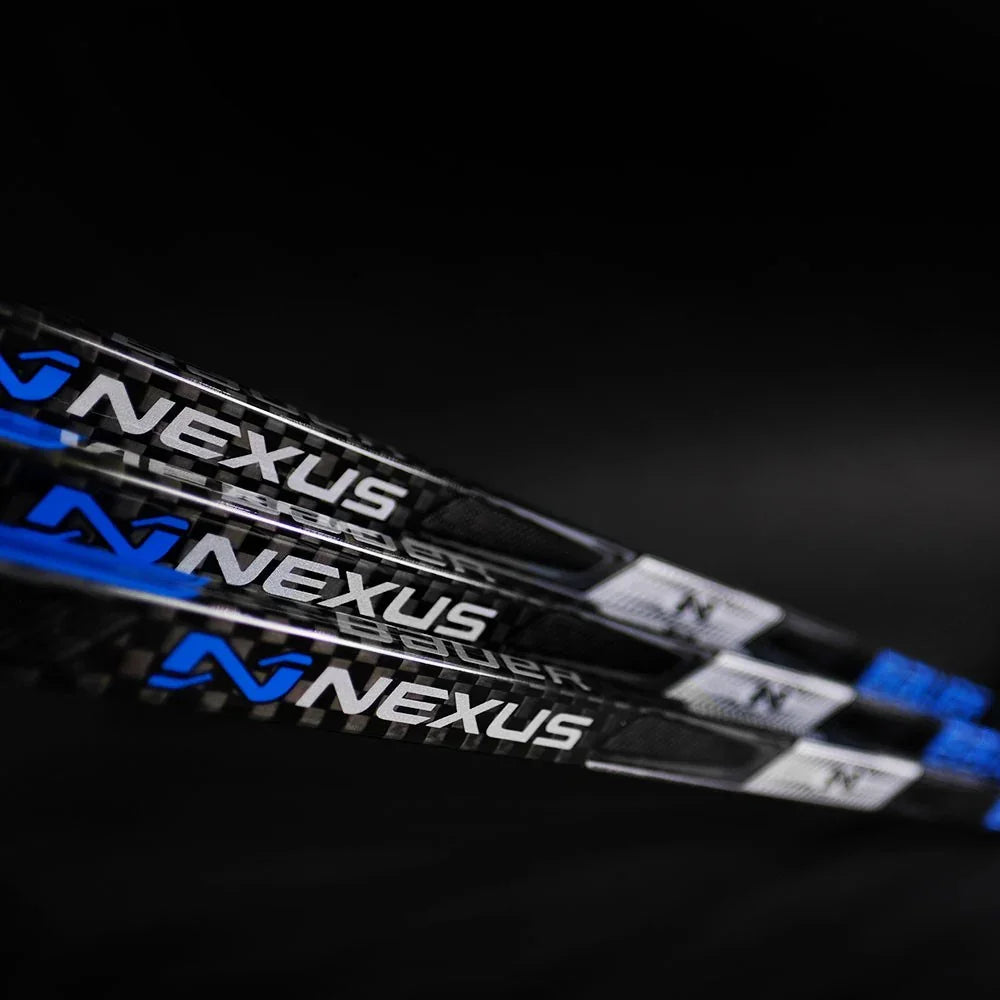 Close-up of Bauer Nexus hockey sticks with black and blue design, The Hockey Shop equipment