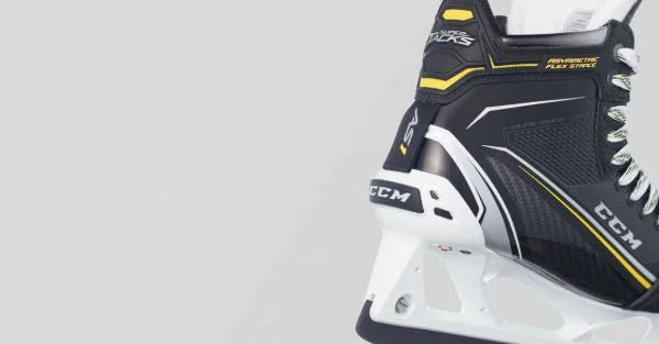Close-up of CCM Super Tacks AS1 hockey skate with black, white, and yellow accents