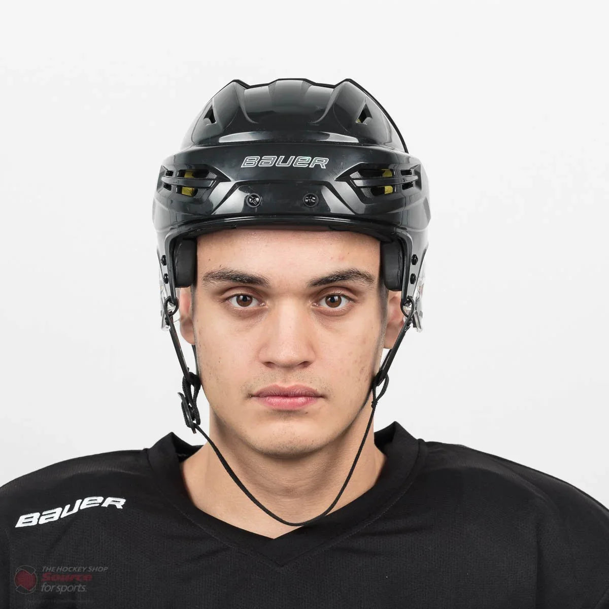 Front view of Bauer Re-Akt 95 hockey helmet worn by player in black jersey at The Hockey Shop