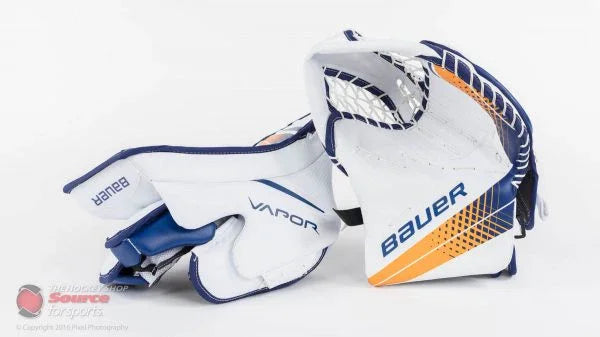 Bauer Vapor hockey goalie trapper and blocker set, white with blue and orange design, on white background.