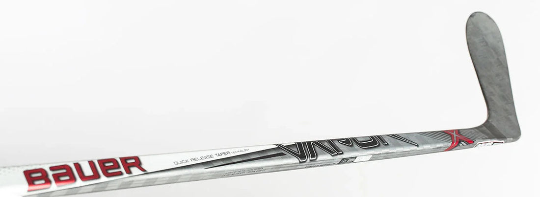 Bauer Vapor hockey stick close-up with silver, red, and black graphics, The Hockey Shop