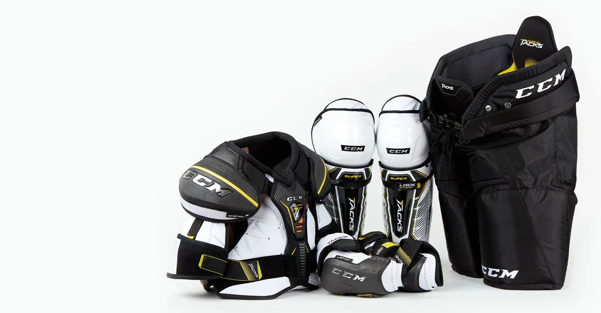 CCM Super Tacks hockey protective gear including shoulder pads, shin guards, gloves, and pants at The Hockey Shop