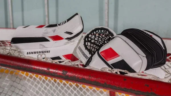 Warrior G3 goalie blocker and trapper gloves on net, hockey gear at TheHockeyShop.com