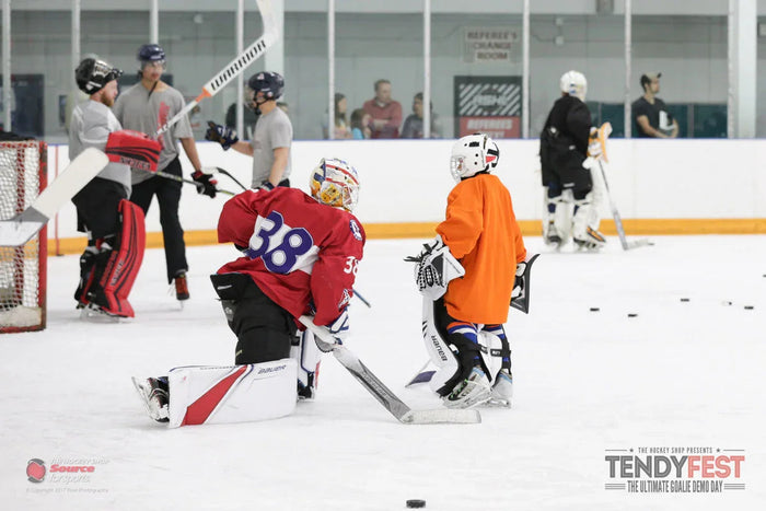 Youth and adult goalies in hockey gear at Tendyfest demo event on ice at TheHockeyShop.com rink