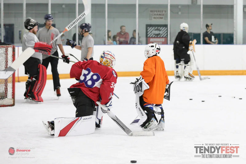 Youth and adult goalies in hockey gear at Tendyfest demo event on ice at TheHockeyShop.com rink