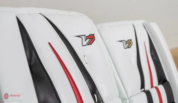 Close-up of Vaughn V7 goalie leg pads in white, black, and red at The Hockey Shop