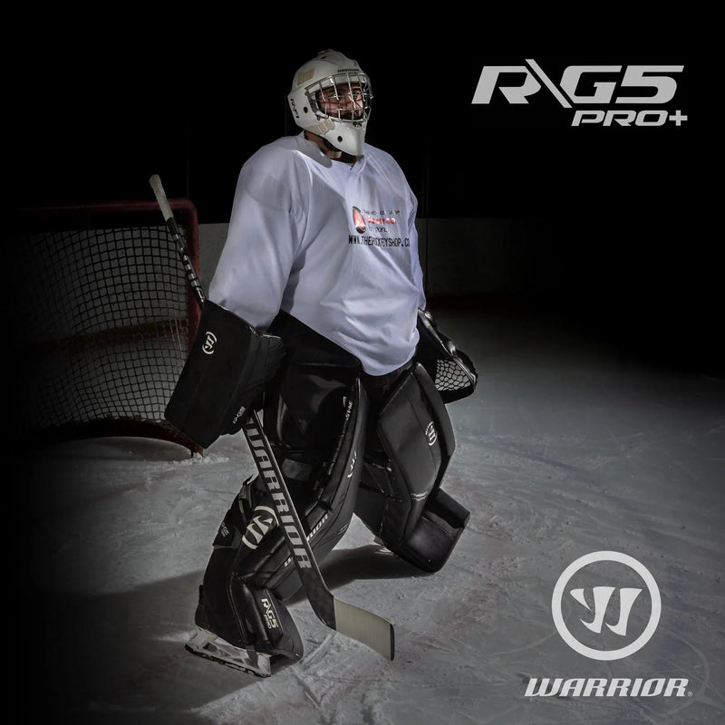 Hockey goalie in Warrior G5 Pro+ gear on ice in front of net, TheHockeyShop.com branding visible.