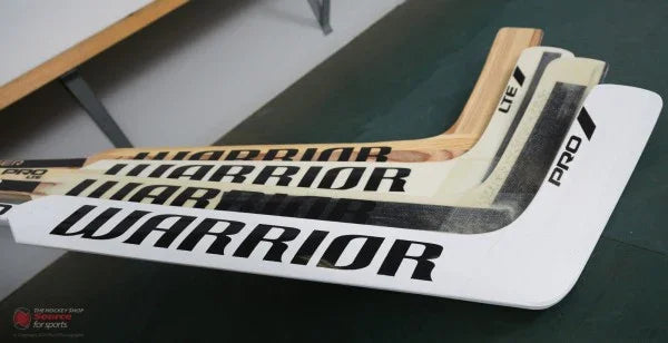 Warrior goalie sticks variety displayed on table at The Hockey Shop, featuring Pro and Lite models.