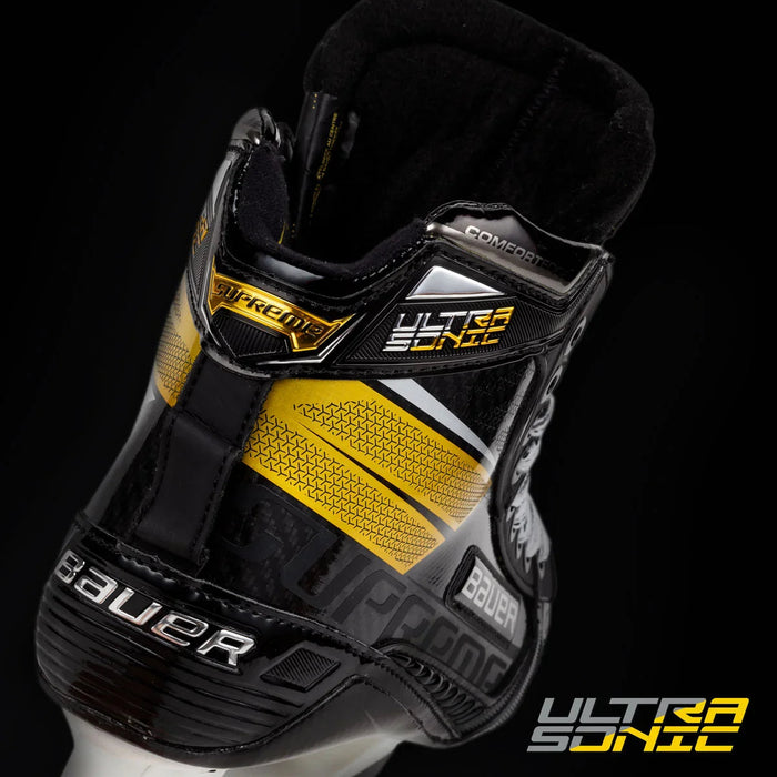 Close-up of Bauer Supreme Ultrasonic hockey skate boot with yellow and black accents at TheHockeyShop.com