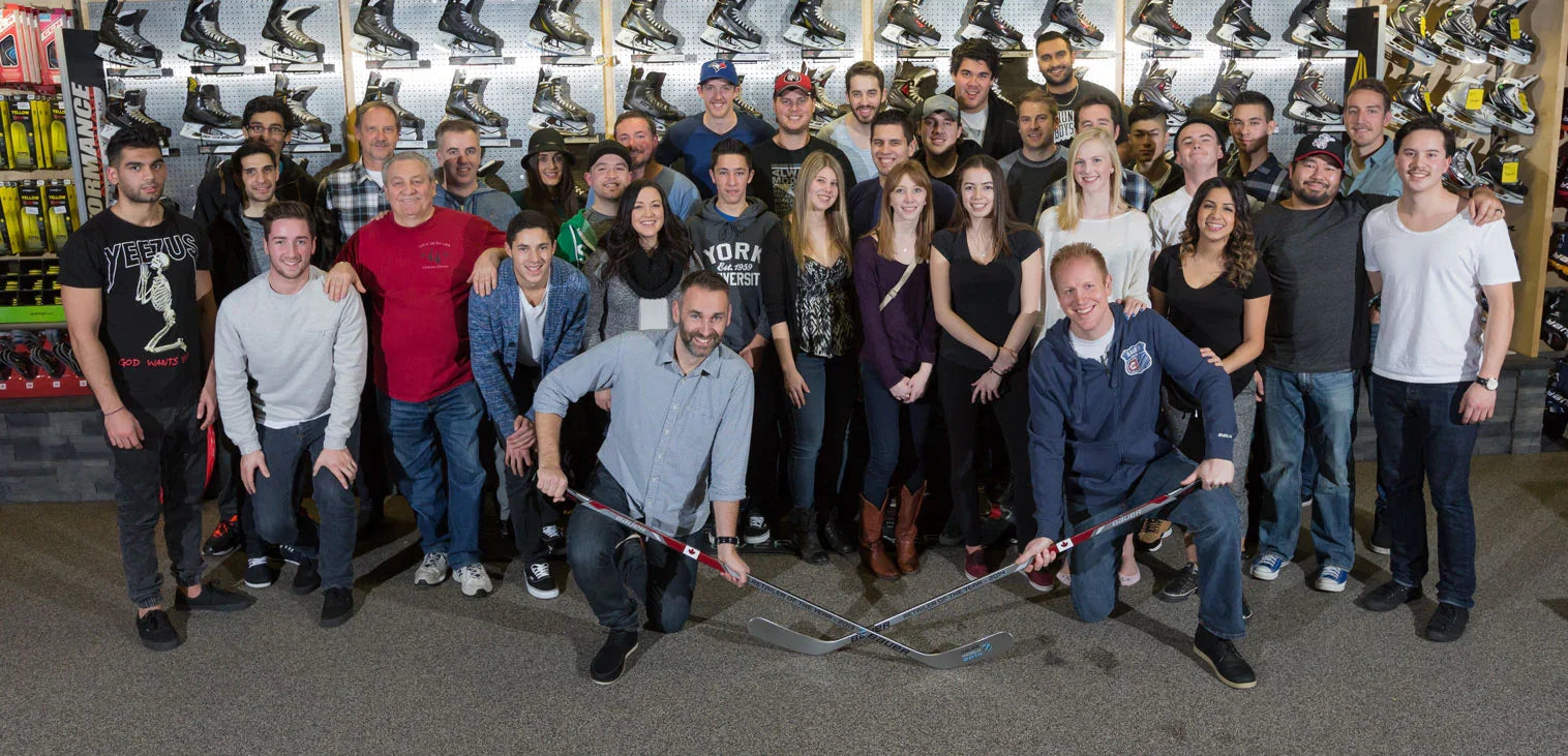 The Hockey Shop staff group photo in front of hockey skates display