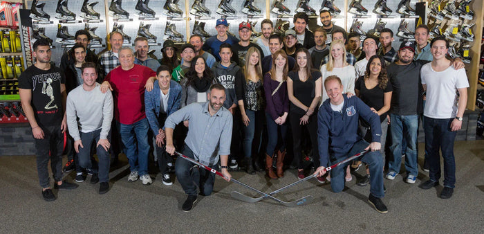 The Hockey Shop staff group photo in front of hockey skates display