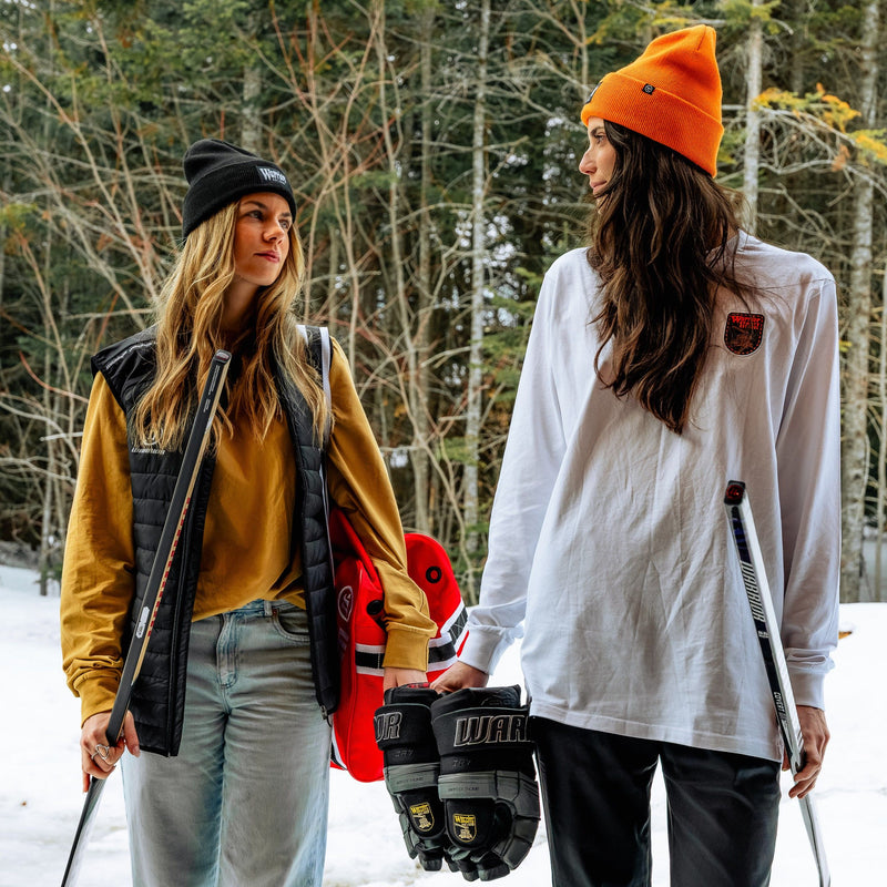two female hockey players with Cabin Fever apparel and gear