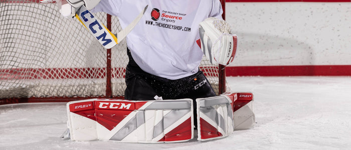 hockey Goalie making a blocker save while in butterfly position