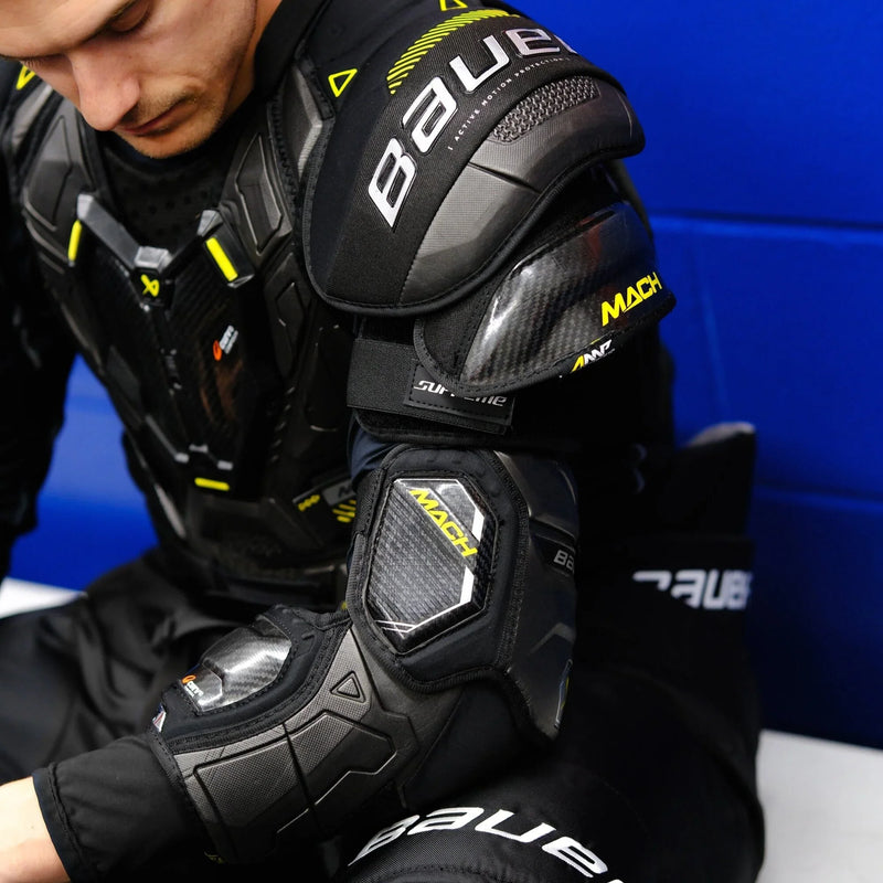 player putting on Bauer Mach protective gear