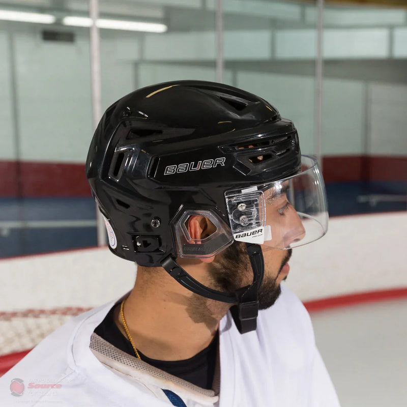 Bauer Reakt 150 hockey helmet with visor worn by player on ice rink at TheHockeyShop.com