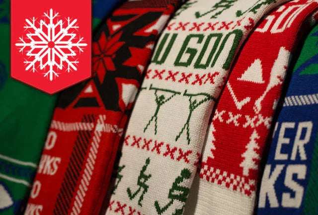 Close-up of colorful hockey-themed holiday ugly sweaters at TheHockeyShop.com