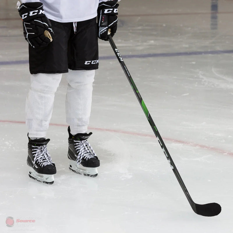 Hockey player in CCM gear holding Ribcor Trigger 4 Pro stick on ice at TheHockeyShop.com