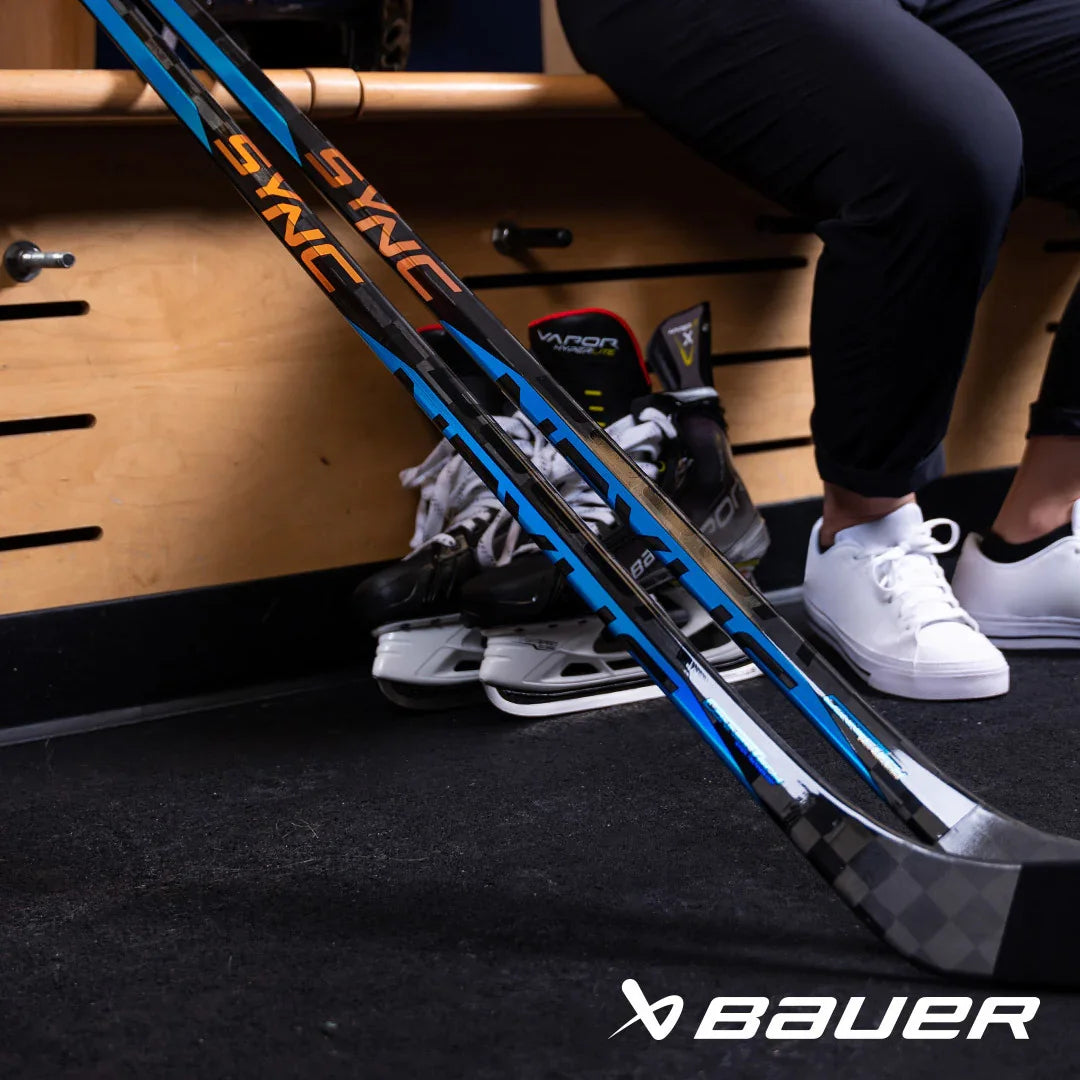 Bauer hockey sticks and skates in locker room at TheHockeyShop.com