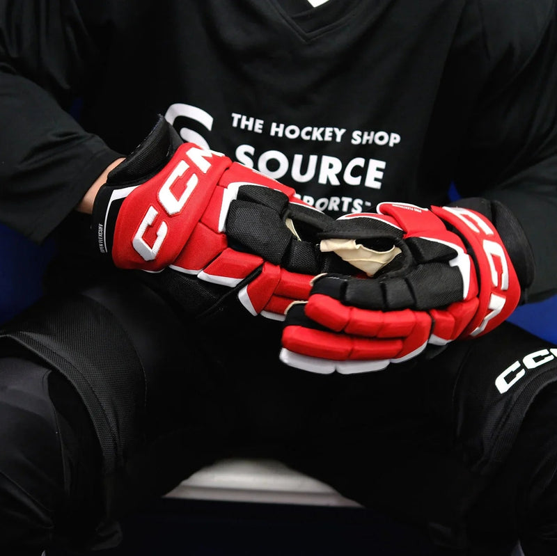 Hockey player wearing red CCM gloves and black gear from The Hockey Shop