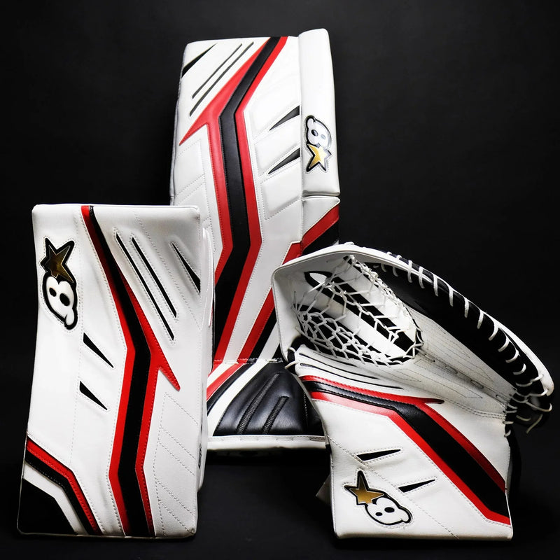 Brian's white, red, and black goalie pads, blocker, and catcher on black background