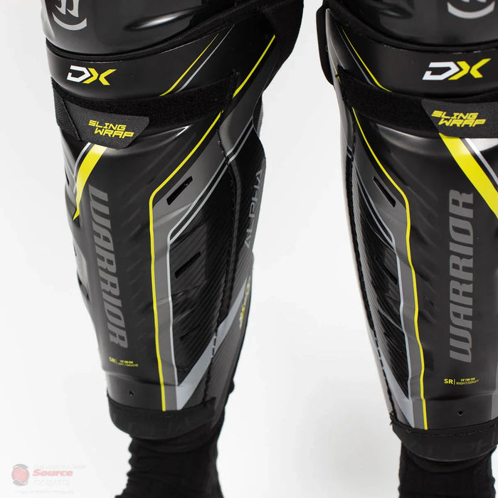 Warrior Alpha DX SR black shin guards with yellow accents, hockey protective gear