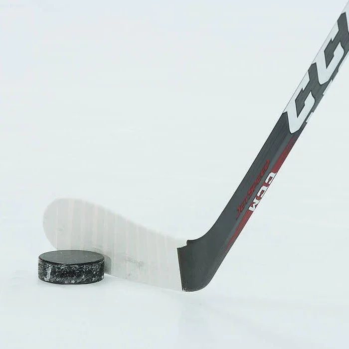 CCM Jetspeed hockey stick blade with puck on ice, The Hockey Shop equipment
