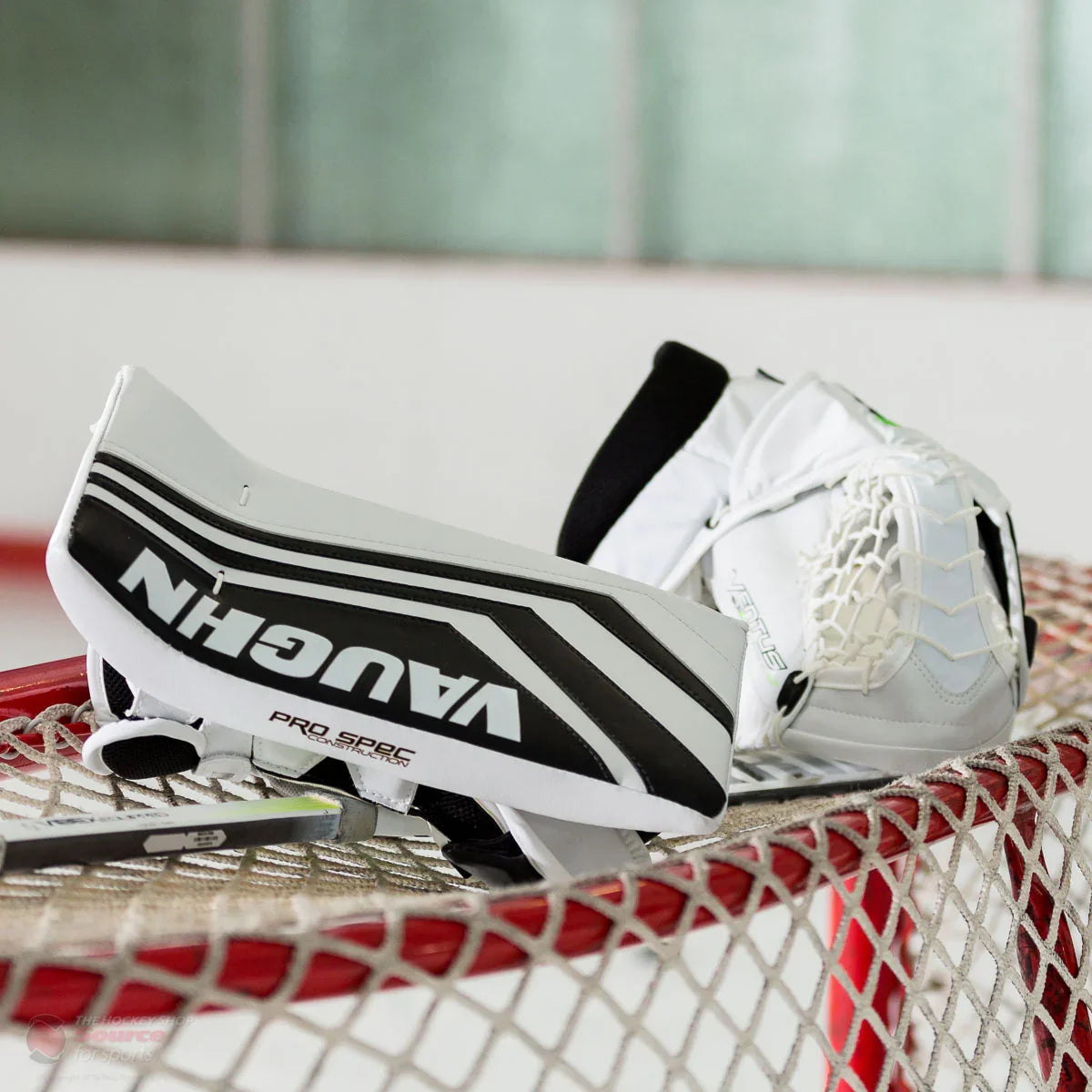 Vaughn Ventus SLR2 Pro Carbon goalie blocker and trapper resting on hockey net, TheHockeyShop.com