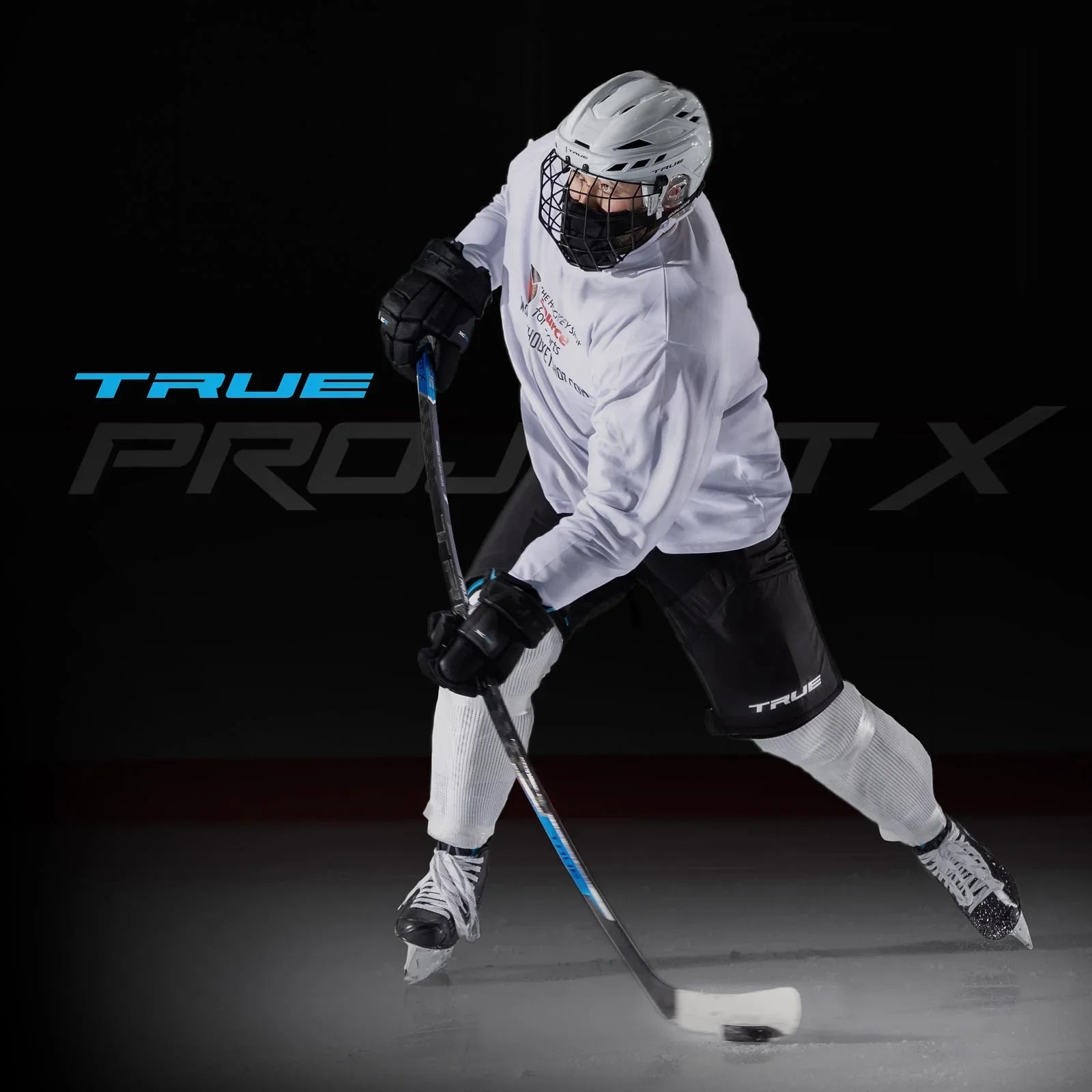 Hockey player in white helmet and gear using True Project X stick on ice, TheHockeyShop.com